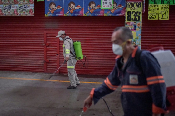Cleaning personnel spray disinfectant at the "Central de Abasto" Mexico City's giant food wholesale market