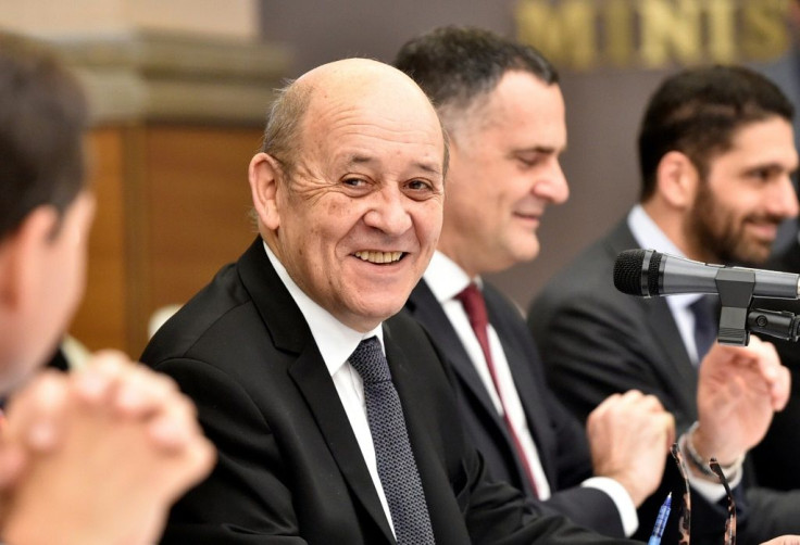 French Foreign Minister Jean-Yves Le Drian, seen here on a March 12, 2020 visit to Algeria, has warned not to "exploit" the coronavirus pandemic
