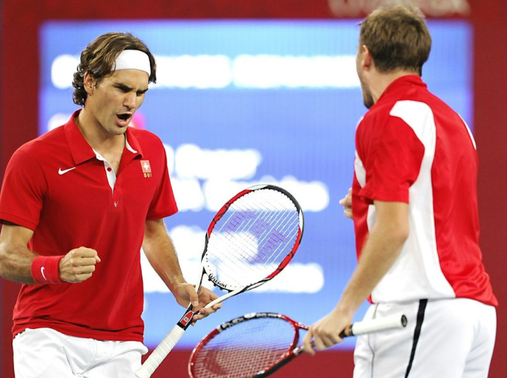 Way back when: Roger Federer and Stan Wawrinka celebrate after winning Olympic gold in the men's doubles in 2008 at Beijing