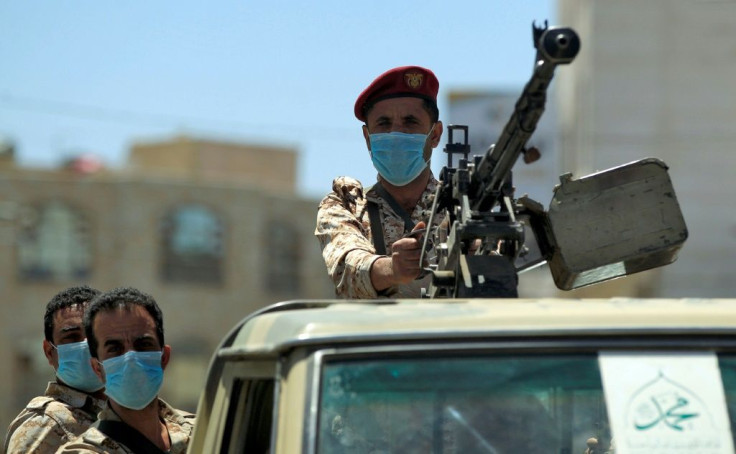A Yemeni soldier loyal to the Huthi rebels mans a machine gun turret in the back of a pickup truck during a patrol in the capital Sanaa