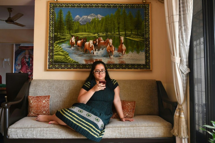 Diya Roy Chowdhury listens to music during a break at her home office