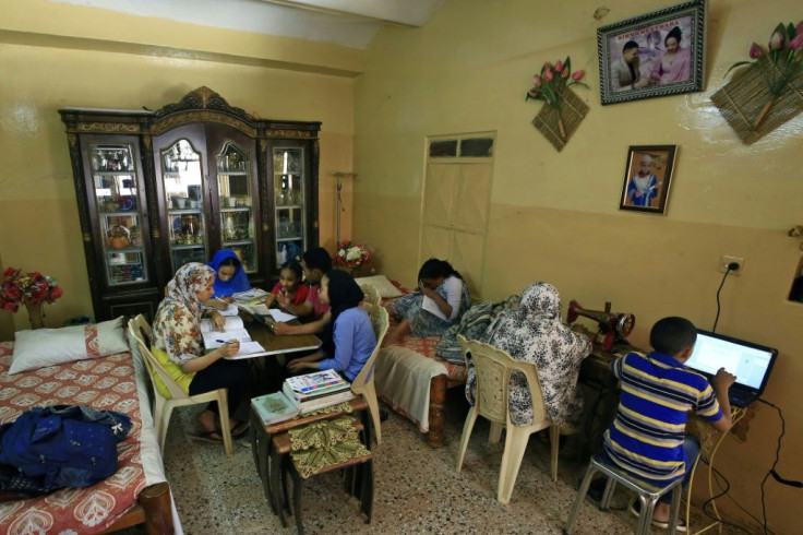 A family studies together at home in Khartoum