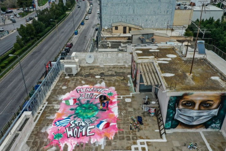 Spraypainted graffiti, inspired by the COVID-19 novel coronavirus, on the roof of the artist's apartment building in Athens