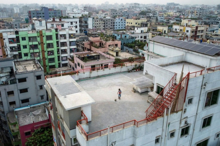 Nine-year-old Samin Sharar plays on the rooftop of his building in Dhaka