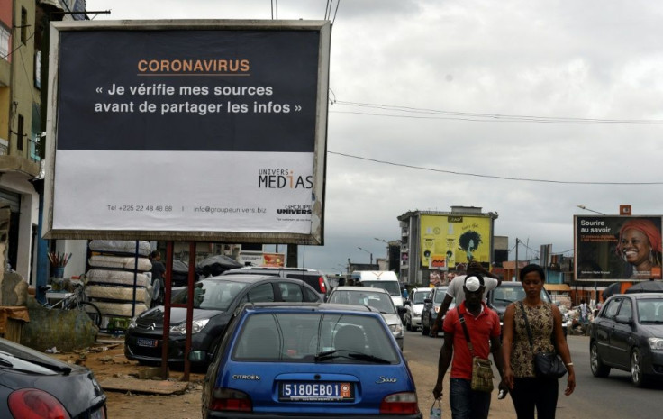 A sign in Abidjan reads 'Coronavirus - I check my sources before sharing news' to warn people against fake news and misinformation about the virus
