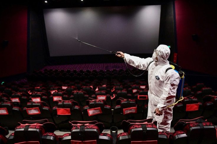 A worker sprays disinfectant in a cinema in the northeastern Chinese city of Shenyang