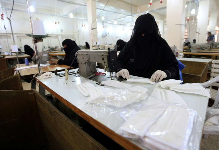 Yemeni women turn out protective masks at a textile factory in the rebel-held capital Sanaa
