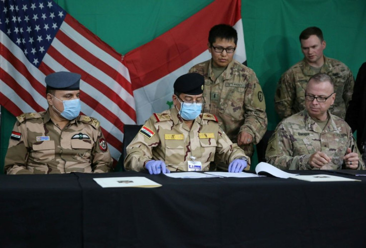 US and Iraqi generals at a pullout ceremony at Iraq's Qayyarah air base