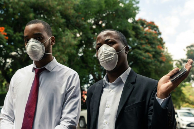 Zimbabwe Hospital Doctors Association president Tawanda Zvakada (R) and treasurer Tapiwa Mungofa speak to press at the Parirenyatwa Hospital in Harare, where they vowed to boycott work unless the government provides protective gear for  COVID-19