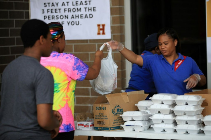 A worker hands out food at Paul Habans Charter School in New Orleans