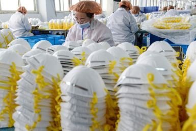 Workers produce face masks at a factory in Handan in China's northern Hebei province