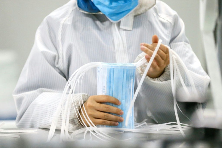 A worker produces face masks at a factory in Qingdao in China's eastern Shandong province