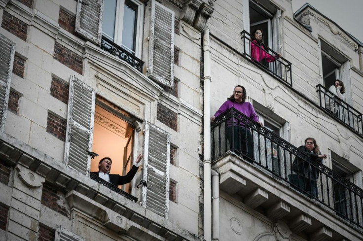 French opera tenor singer Stephane Senechal performs 'O Sole Mio' from his window in Paris on the tenth day of a strict lockdown in France