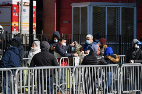 New Yorkers queue outside Elmhurst Hospital Center in Queens to get tested for the coronavirus