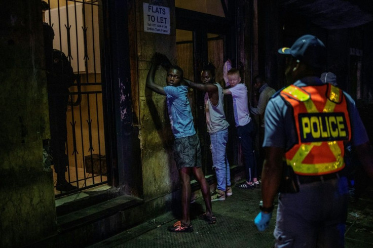 Police line up suspected lockdown violators in Johannesburg's Central Business District