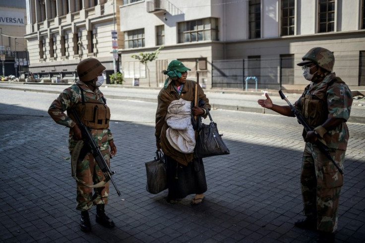 Troops escorted a homeless woman in Johannesburg to a gathering point