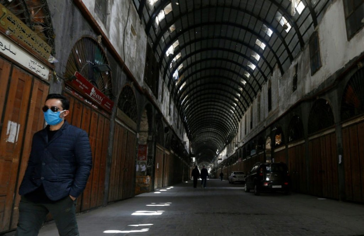 A man walks in the mostly empty Hamidiya bazaar in Syria's capital Damascus on March 24