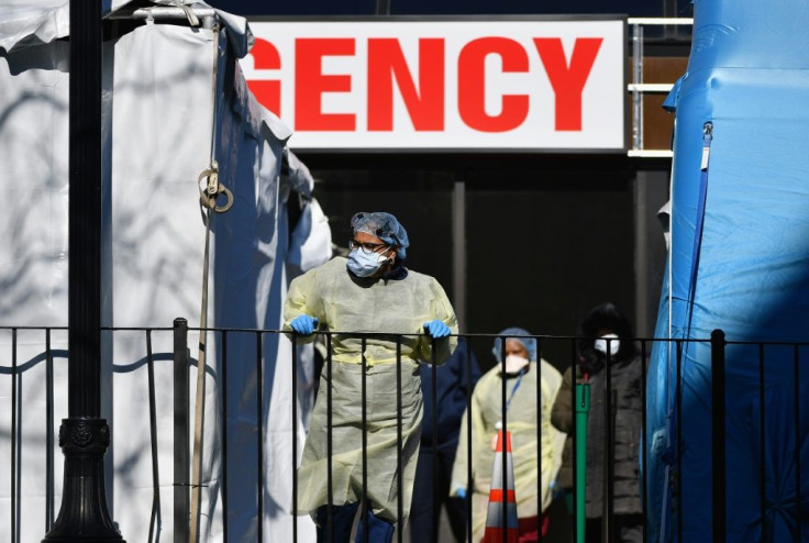 Medical personnel outside New York's Elmhurst Hospital Center, where 13 COVID-19 patients died in 24 hours