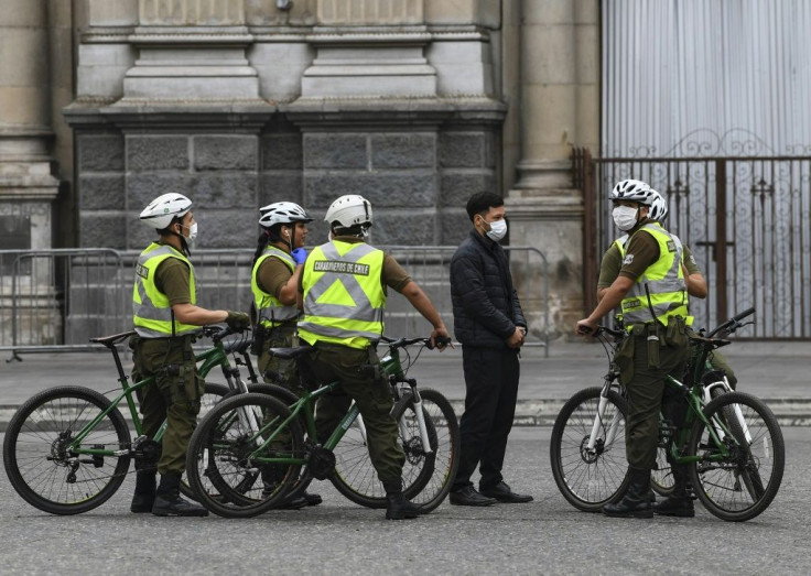 Chilean soldiers carry out a check in Santiago, where people in seven of the city's main communes will enter into total quarantine for a week starting Thursday night