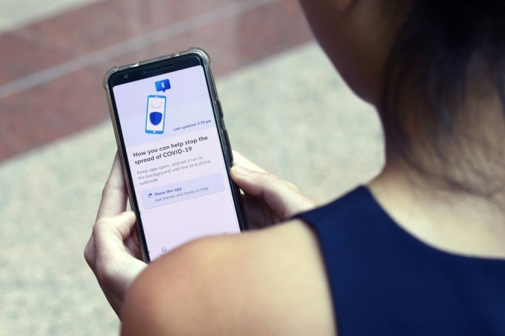 A Government Technology Agency staffer demonstrates Singapore's app called TraceTogether, as a preventive measure against the COVID-19 outbreak