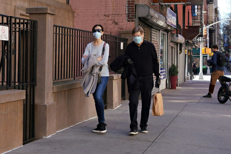 Two people wearing protective masks walk in New York city's Upper East Side neighborhood as the coronavirus continues to spread