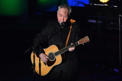 US singer-songwriter John Prine, pictured June 2019, has been hospitalized and intubated due to a "sudden onset of Covid-19 symptoms," according to his family