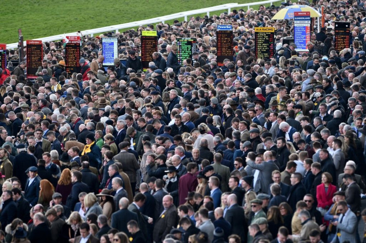 Racegoers attend the final day of the Cheltenham Festival horse racing meeting in Gloucestershire, south-west England, on March 13, 2020