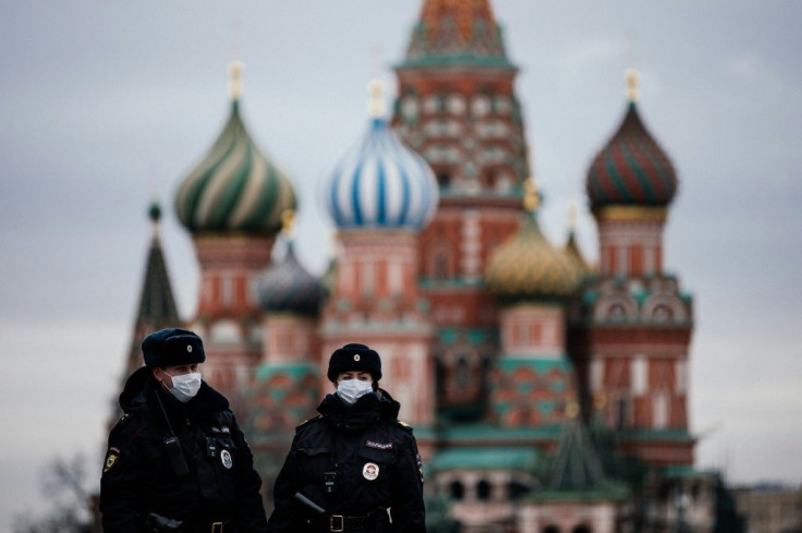 Russian police officers patrol a deserted Red square in front of Saint Basil's Cathedral in Moscow as the capital and other parts of Russia go into lockdown to curb the novel coronavirus.
