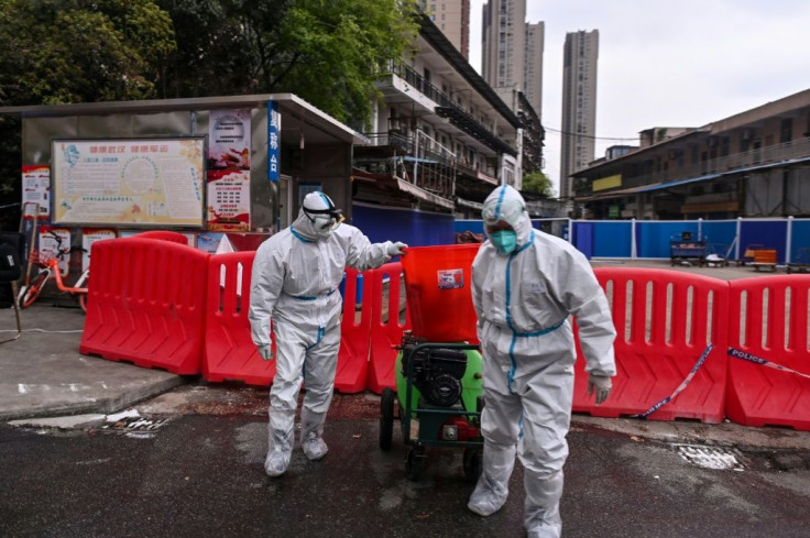 The market has been sealed but police tape, chest-high red barriers and staff in hazmat suits serve as reminders of its ground-zero status