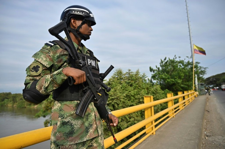 A Colombian soldier guards a checkpoint in rural Jamundi, Valle del Cauca, on February 14, after the ELN threatened a three-day "armed strike" against the government