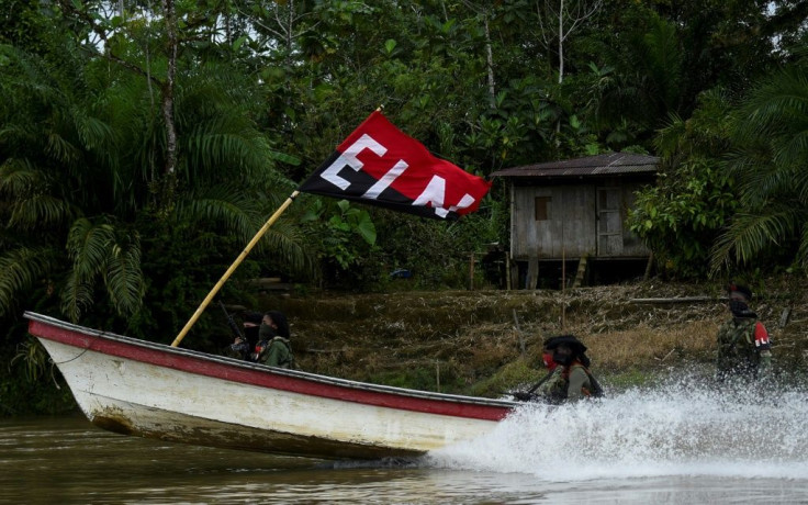 ELN guerrillas patrol a jungle river in Colombia's Choco department on May 23, 2019