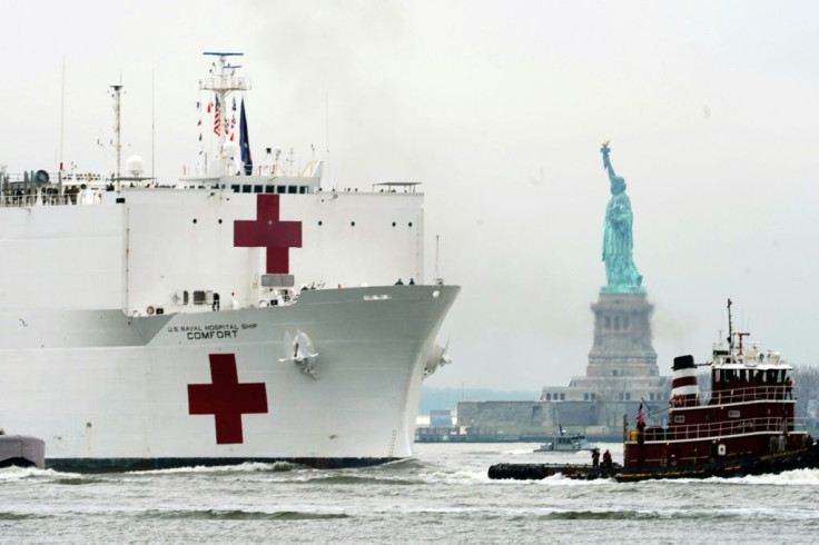 The USNS Comfort medical ship moves up the Hudson River past the Statue of Liberty as it arrives on March 30, 2020 in New York