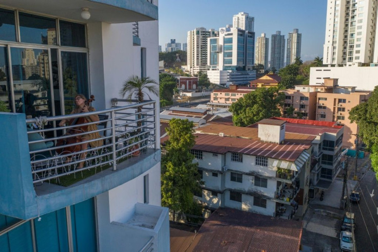 Uruguayan cellist Karina Nunez plays on the balcony of her Panama City apartment during the mandatory lockdown to halt the spread of the deadly new coronavirus