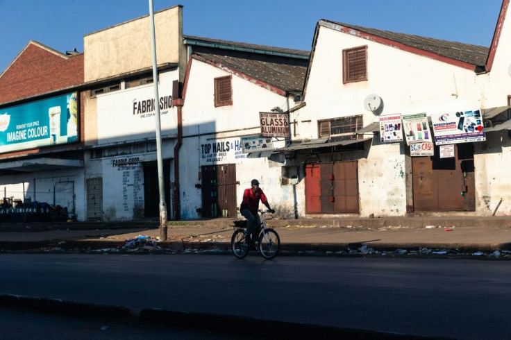 A lone cyclist makes his way in the usually bustling part of downtown Harare