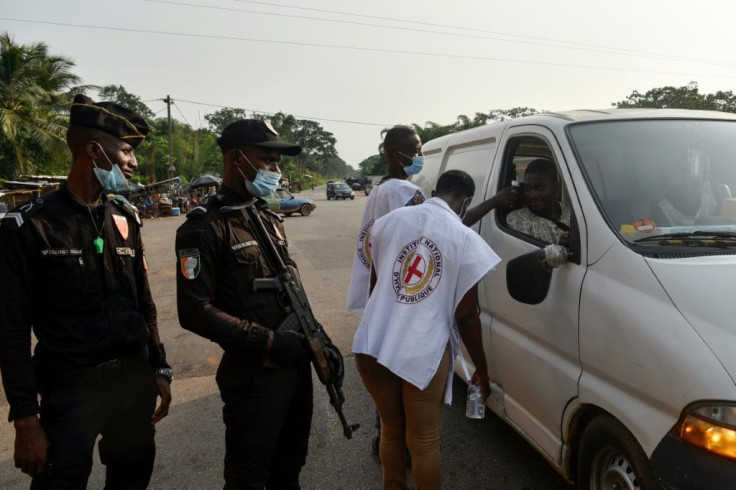 National Institute of Public Hygiene staff check the temperatures of people in Abidjan, Ivory Coast