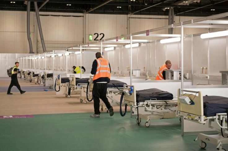 Members of the military and private contractors help to turn the ExCel centre in London into a field hospital to be known as the NHS Nightingale,  to help with the COVID-19 pandemic
