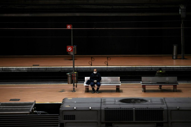 A man wearing a face mask sits on a bench on a platform of Atocha railway station in Madrid during the national lockdown