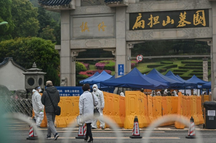 Hazmat-suit-wearing security personnal and police were present at Wuhan's Biandanshan Cemetary as people filed past to lay their loved ones to rest