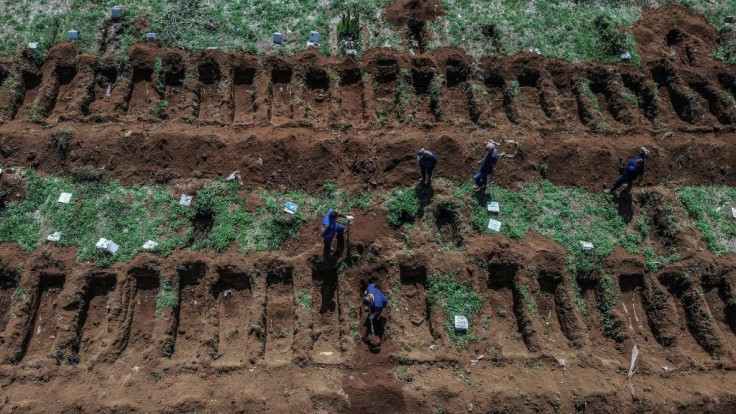 Staff dig graves at Vila Formosa cemetery, in outskirts of Sao Paulo, Brazil