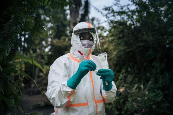 A staff member of the Congolese Ministry of Health prepares the sampling equipment to perform a COVID-19 test at a private residence in Goma, northeastern Democratic Republic of Congo