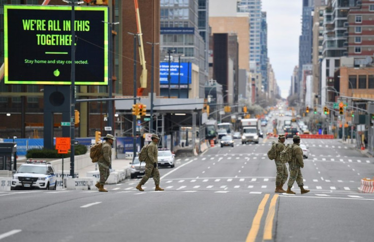 Members of the Army National Guard cross the street by the Jacob K. Javits Convention Center on March 31, 2020 in New York City