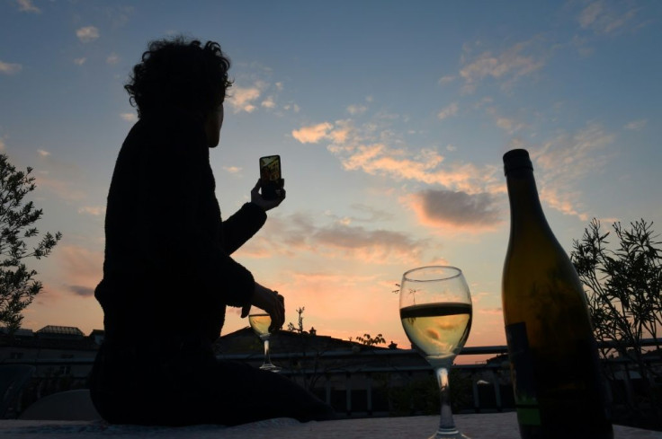 A French woman under lockdown raises a glass of wine