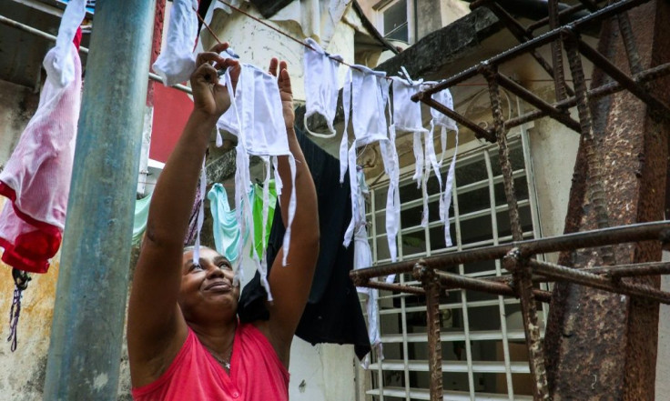 A woman puts face masks that she made for neighbors out to dry in the Havana neighborhood of Vedado