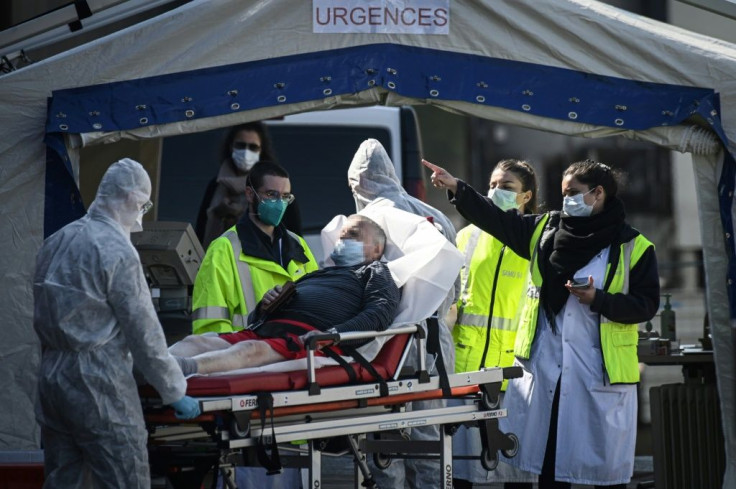 Medical personnel tend to a patient at the reception of the Emergency Room, set up in a tent, in a courtyard of the Henri Mondor Hospital in Creteil in the suburbs of Paris