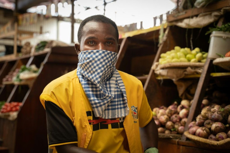 Masked: A phone credit salesman wears a dishcloth to cover his face at Kaveza market in Kigila. The country is in lockdown, and only essential stores are open.