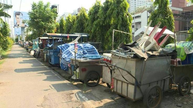 Empty food carts with chairs stacked on them sit in a lot next to a busy Bangkok highway -- the latest casualty of a deadly coronavirus which has stunted global travel and economies.