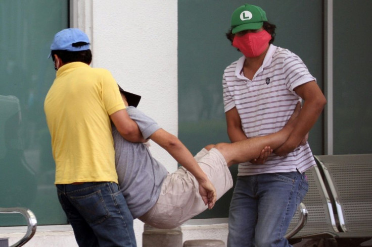 People carry a sick man into a hospital in Guayaquil on April 1