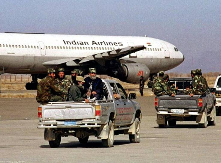 Afghan Taliban militia head towards a hijacked Indian Airlines plane in Kandahar in December 1999