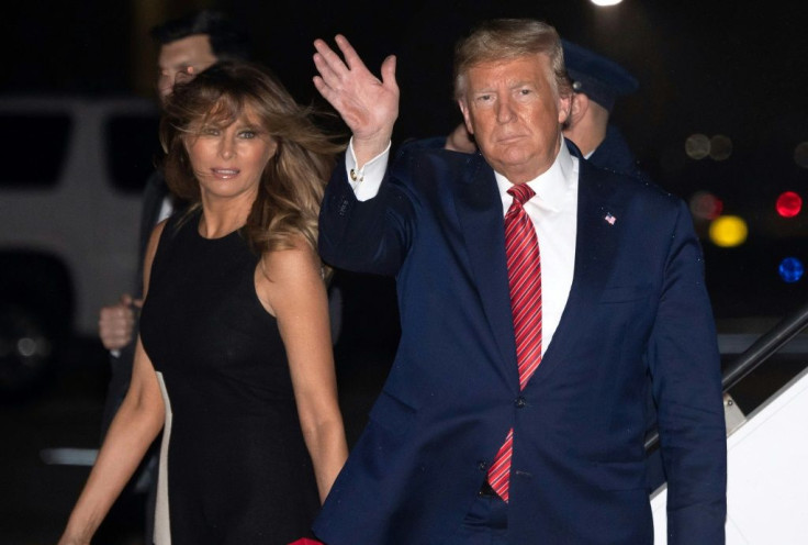 US President Donald Trump, shown here with his wife Melania arriving in Palm Beach on February 14, 2020, handed control of the Trump Organization over to his sons after his inauguration