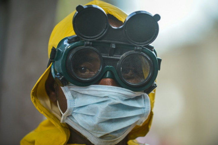 A worker in protective gear disinfects a metro carriage in Addis Ababa, Ethiopia